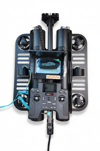 A black dual-channel RC drone controller with an attached screen and multiple mounting brackets, shown against a plain white background.